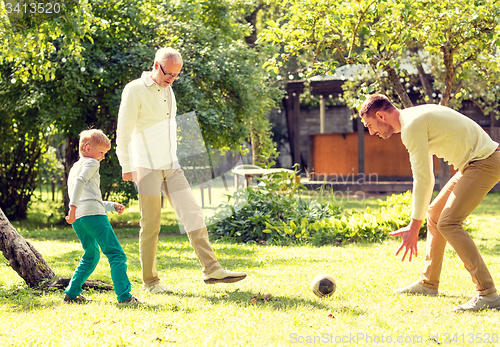 Image of happy family playing football outdoors