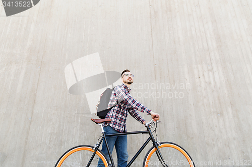 Image of hipster man with fixed gear bike and backpack