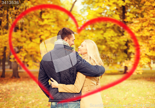 Image of romantic couple kissing in the autumn park