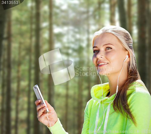 Image of happy woman with smartphone and earphones