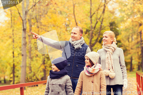 Image of happy family in autumn park