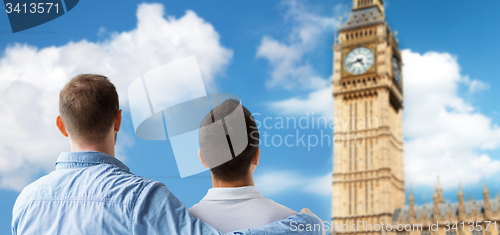 Image of close up of male gay couple hugging over big ben