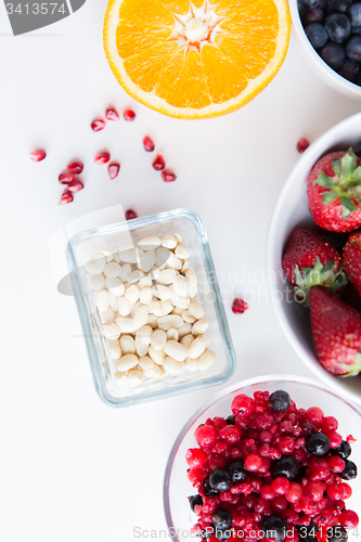 Image of close up of fruits and berries in bowls on table