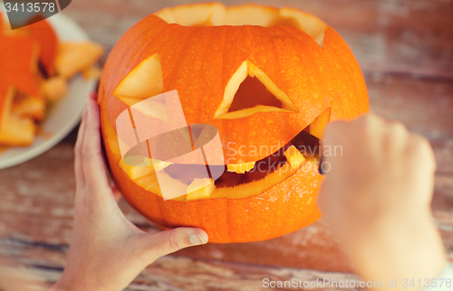 Image of close up of woman with pumpkins at home