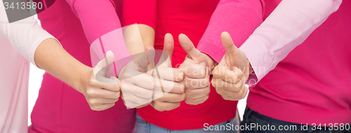 Image of close up of women in pink shirts showing thumbs up