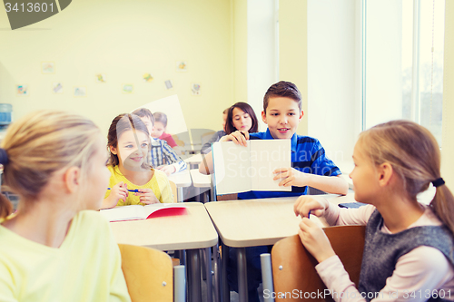 Image of group of school kids writing test in classroom