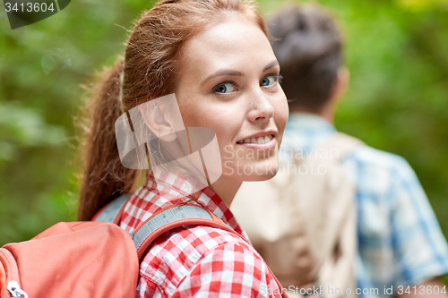 Image of group of smiling friends with backpacks hiking