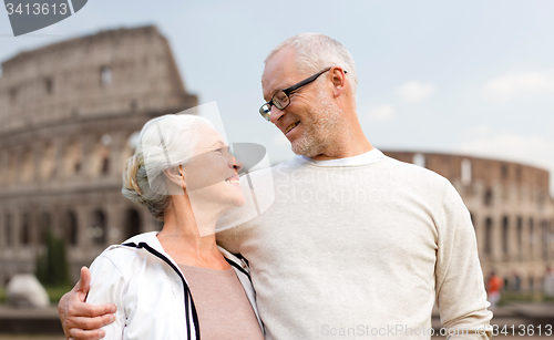 Image of happy senior couple over coliseum in rome, italy