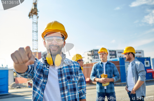 Image of builders pointing finger at you on construction