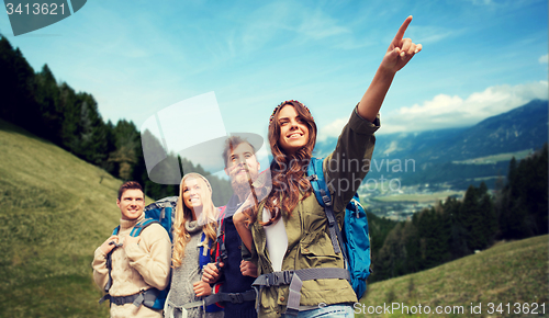 Image of group of smiling friends with backpacks hiking