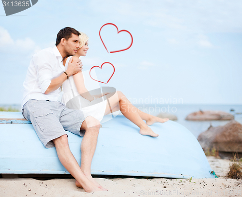 Image of couple sitting on boat at sea side