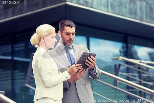 Image of businesspeople with tablet pc outdoors