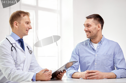 Image of male doctor and patient with clipboard at hospital