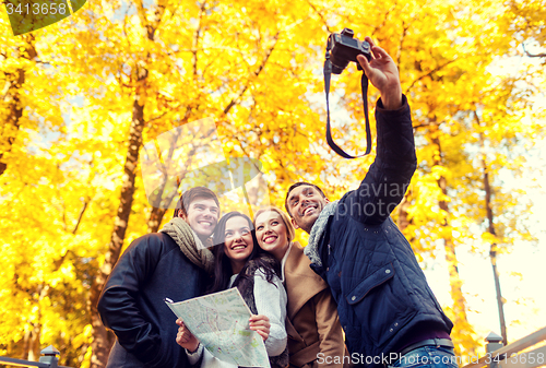 Image of group of friends with map outdoors