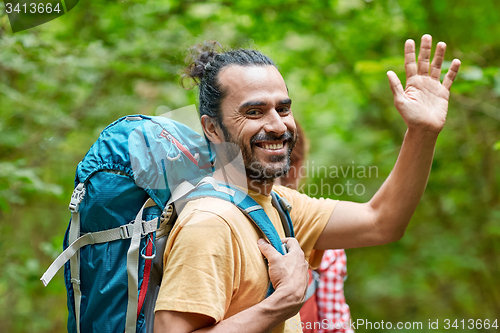 Image of group of smiling friends with backpacks hiking