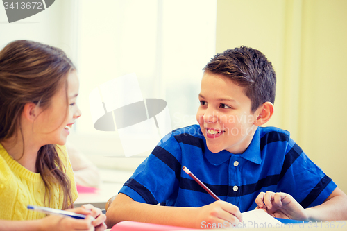 Image of group of school kids writing test in classroom