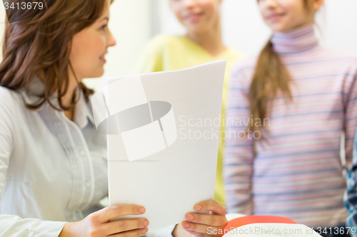 Image of close up of school kids with teacher in classroom