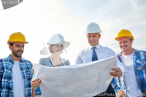 Image of group of builders and architects with blueprint