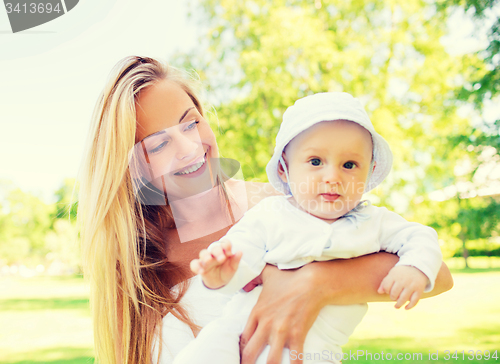 Image of happy mother with little baby in park