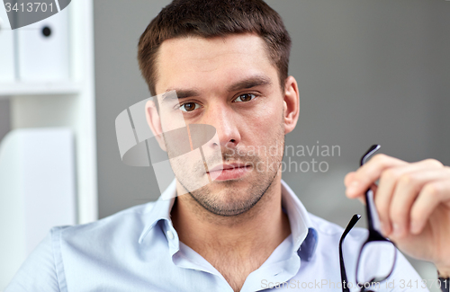 Image of portrait of businessman with eyeglasses at office