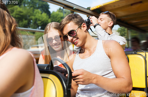 Image of happy couple with guidebook traveling by tour bus