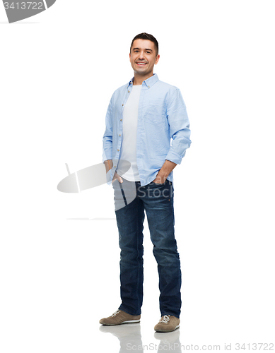 Image of smiling man with hands in pockets