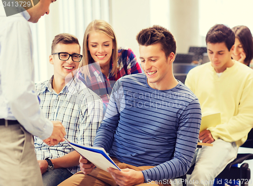 Image of group of students and teacher with notebook