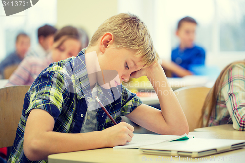 Image of group of school kids writing test in classroom