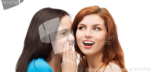 Image of one girl telling another secret