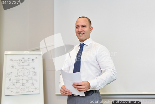 Image of smiling businessman on presentation in office