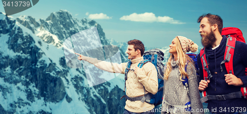 Image of group of smiling friends with backpacks hiking