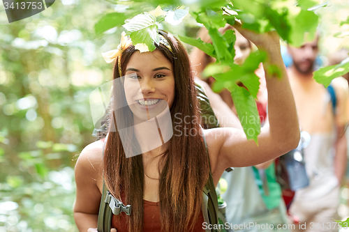 Image of group of smiling friends with backpacks hiking