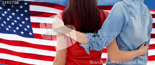 Image of close up of women couple over american flag