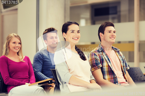 Image of group of smiling students in lecture hall