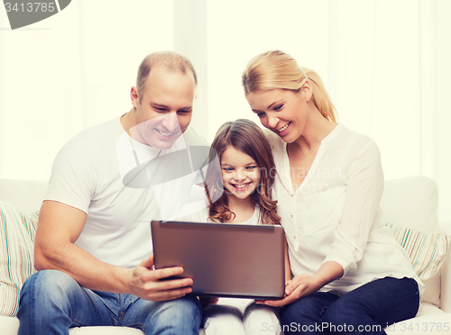 Image of parents and little girl with laptop at home