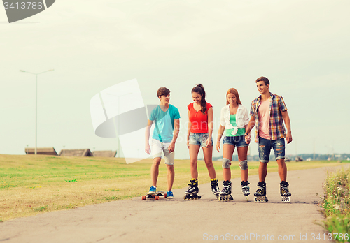 Image of group of smiling teenagers with roller-skates