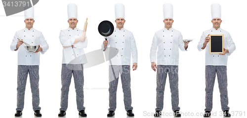 Image of happy male chef cook holding blank menu board