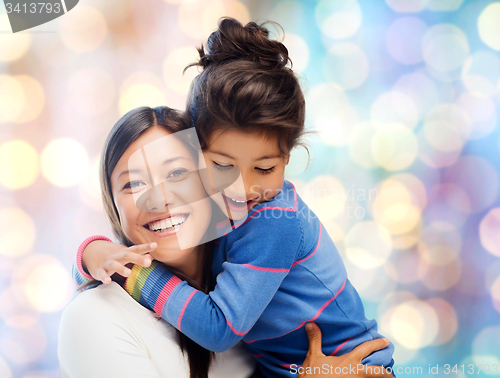 Image of happy mother and daughter hugging