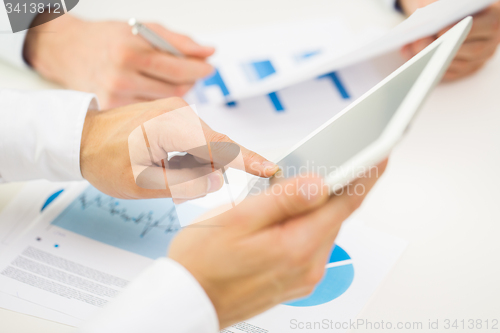 Image of close up of businessman hands with tablet pc