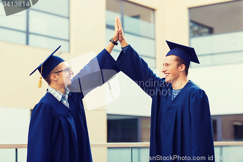 Image of smiling students in mortarboards