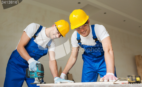 Image of group of builders with tools indoors