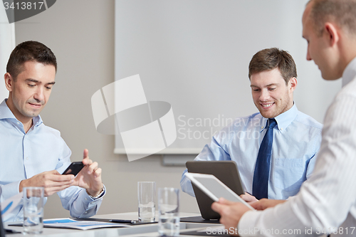 Image of businesspeople with smartphone and tablet pc