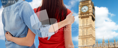 Image of close up of lesbian couple hugging over big ben