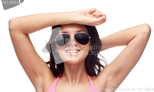 Image of happy woman in sunglasses and swimsuit