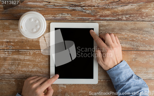 Image of close up of male hands with tablet pc and coffee