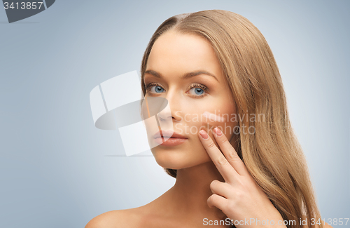 Image of woman with pale and dark foundation tone on face