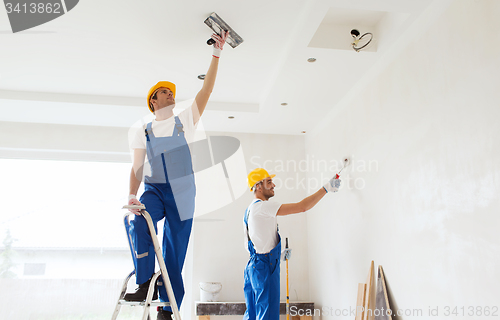 Image of group of builders with tools indoors