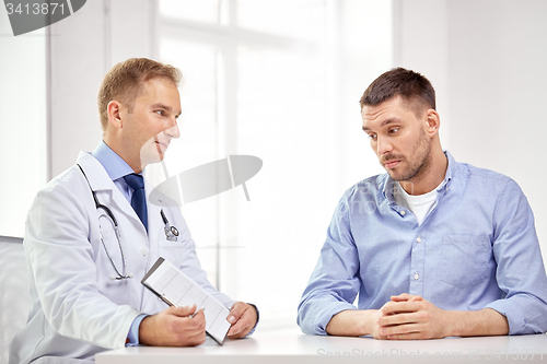 Image of doctor and patient with cardiogram on clipboard