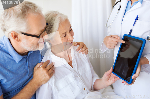 Image of senior woman and doctor with tablet pc at hospital