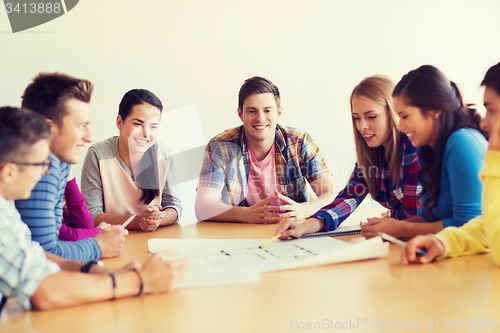 Image of group of smiling students with blueprint